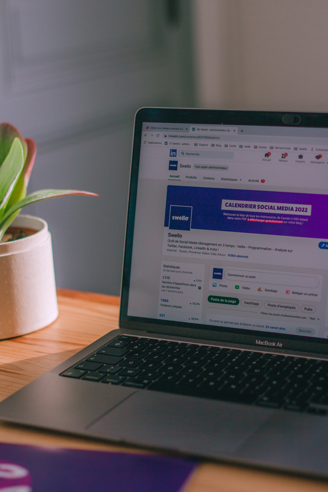 a-laptop-computer-sitting-on-top-of-a-wooden-desk-j-lrdisrjli