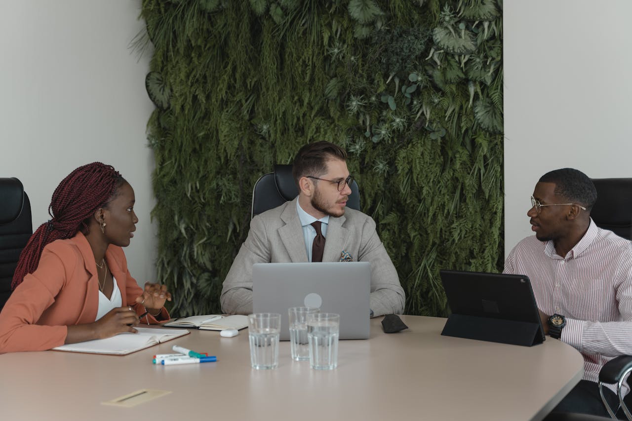 Professionals engaging in a collaborative meeting around a modern conference table.